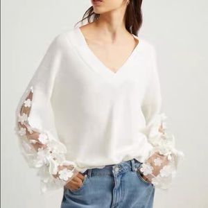 white elegant sweater with knots